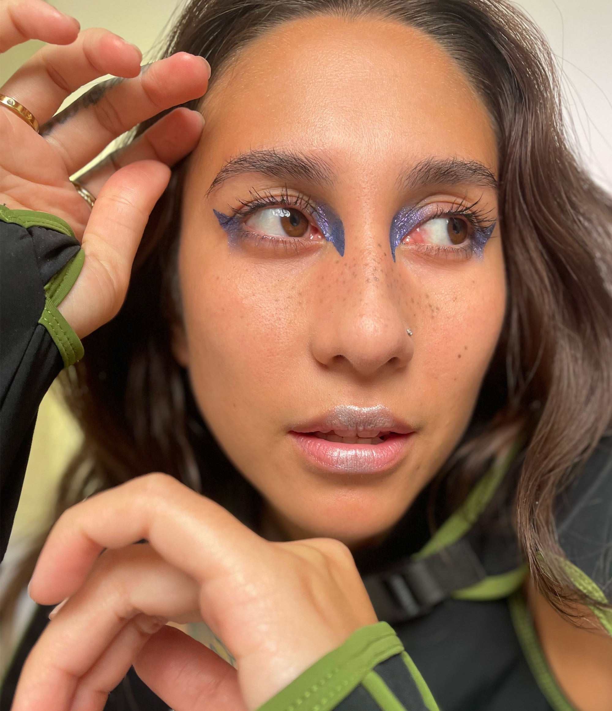 Model with medium tone skin wearing Colorwand in costas around their inner and outer eyes.