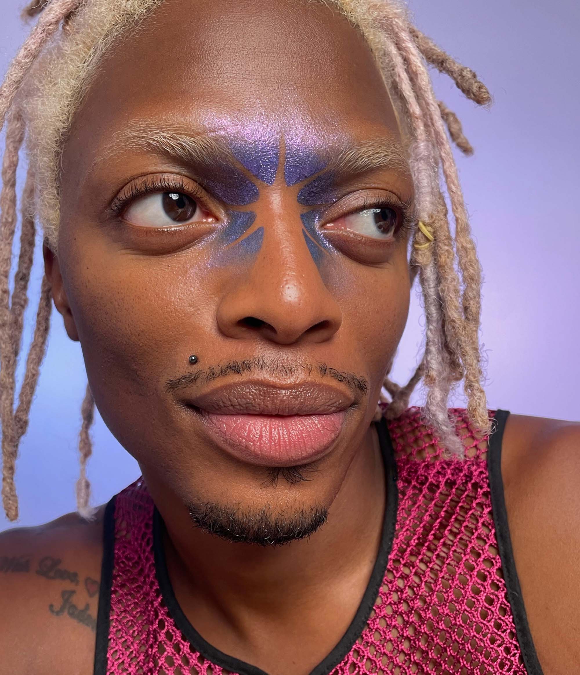 Model with dark skin tone wearing Colorwand in costas between their brows and along their nose