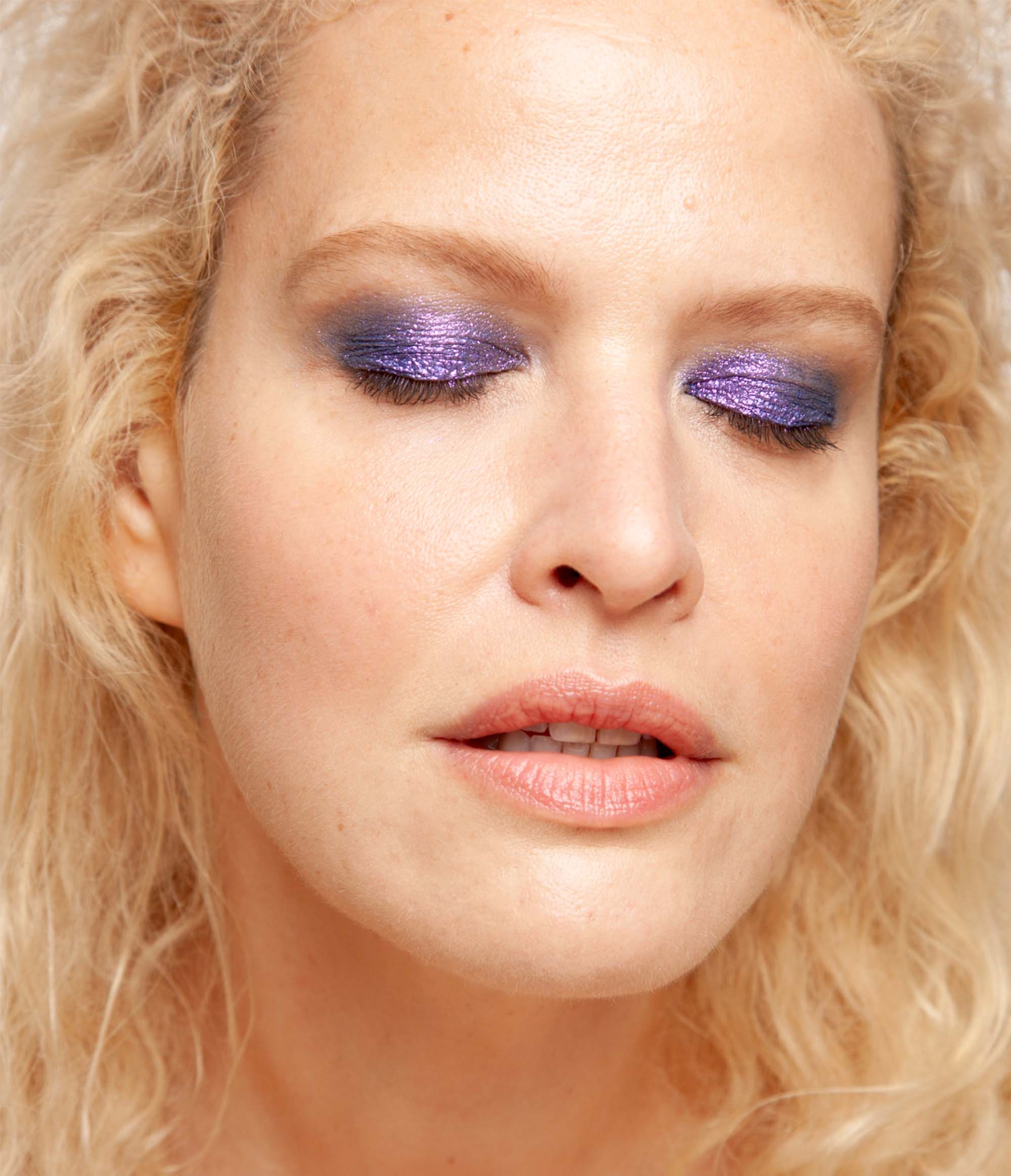 Model with light skin tone wearing Colorwand in costas on her eyes.