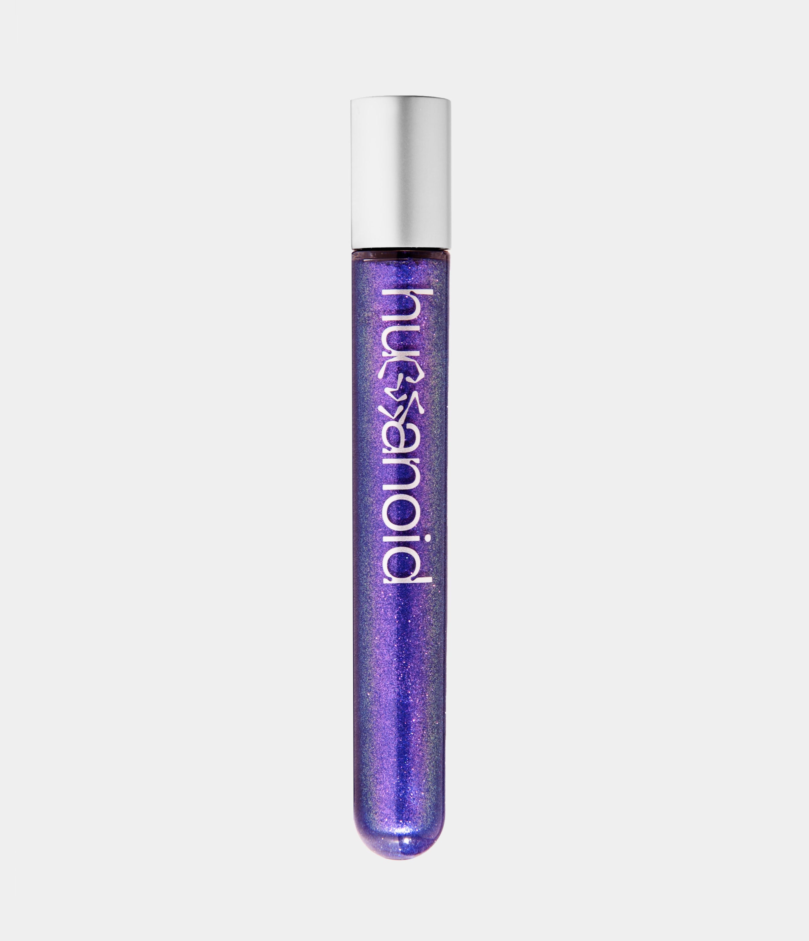 Transparent tube of purple shimmery eye and body makeup with a silver cap