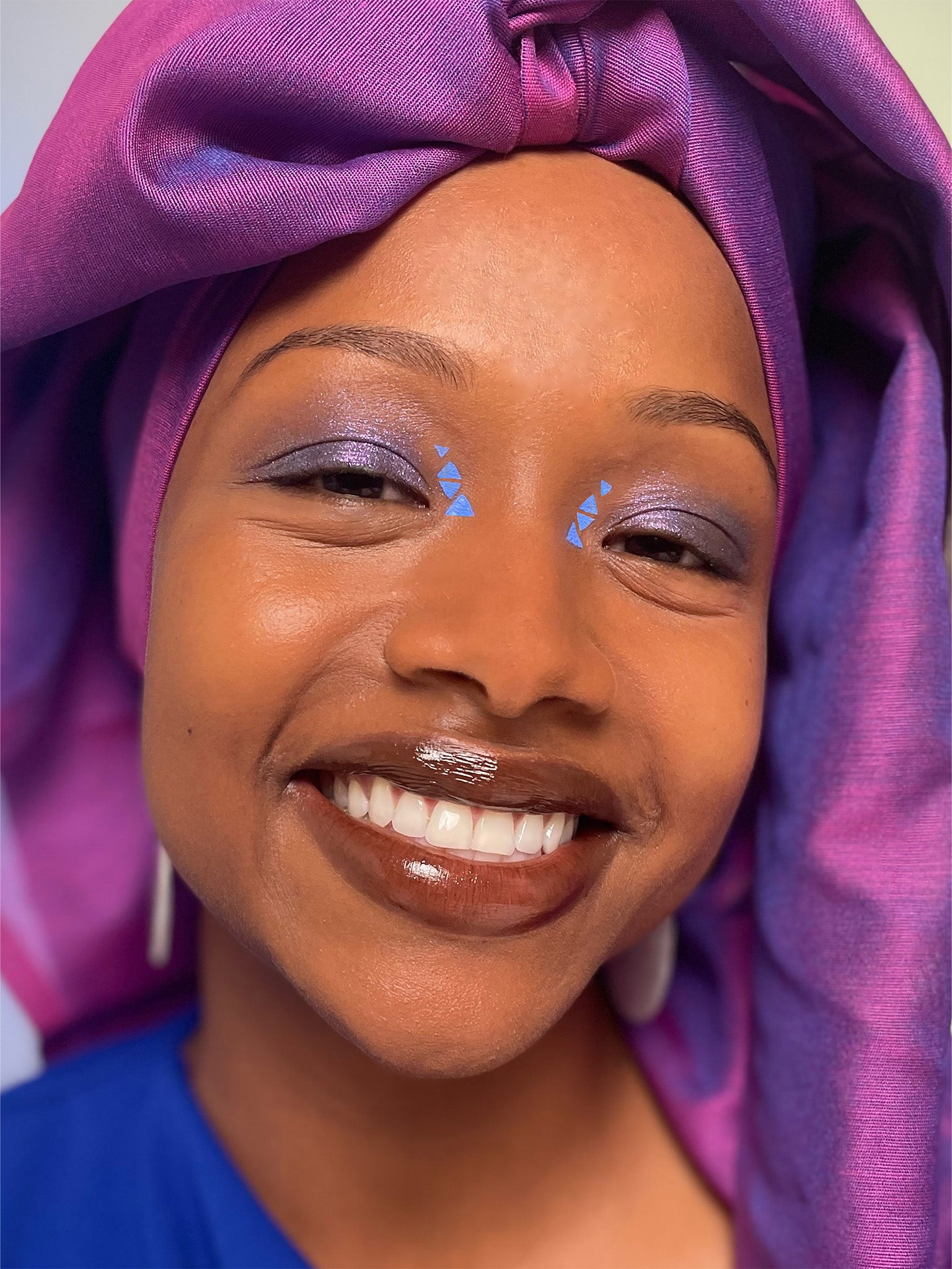 Model with dark skin tone wearing a humanoid skinwear Costas and Benitoite across their eyelids and inner eyes. 