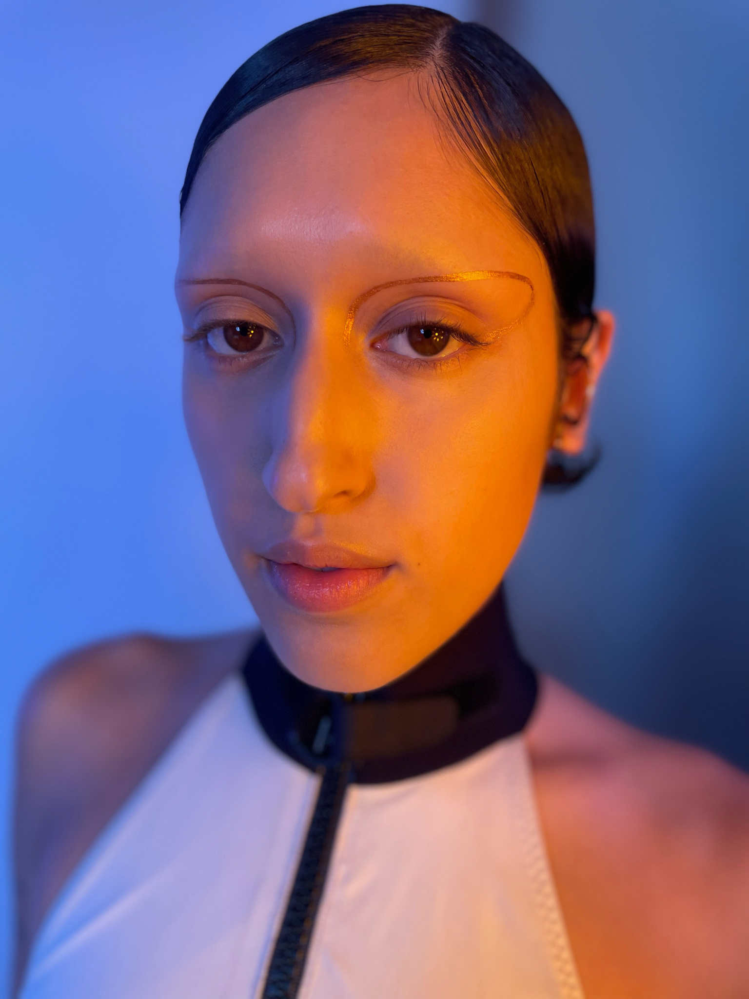 Model with medium skin tone showcasing deepdive colorpot in Eventide with a design around their eyes.