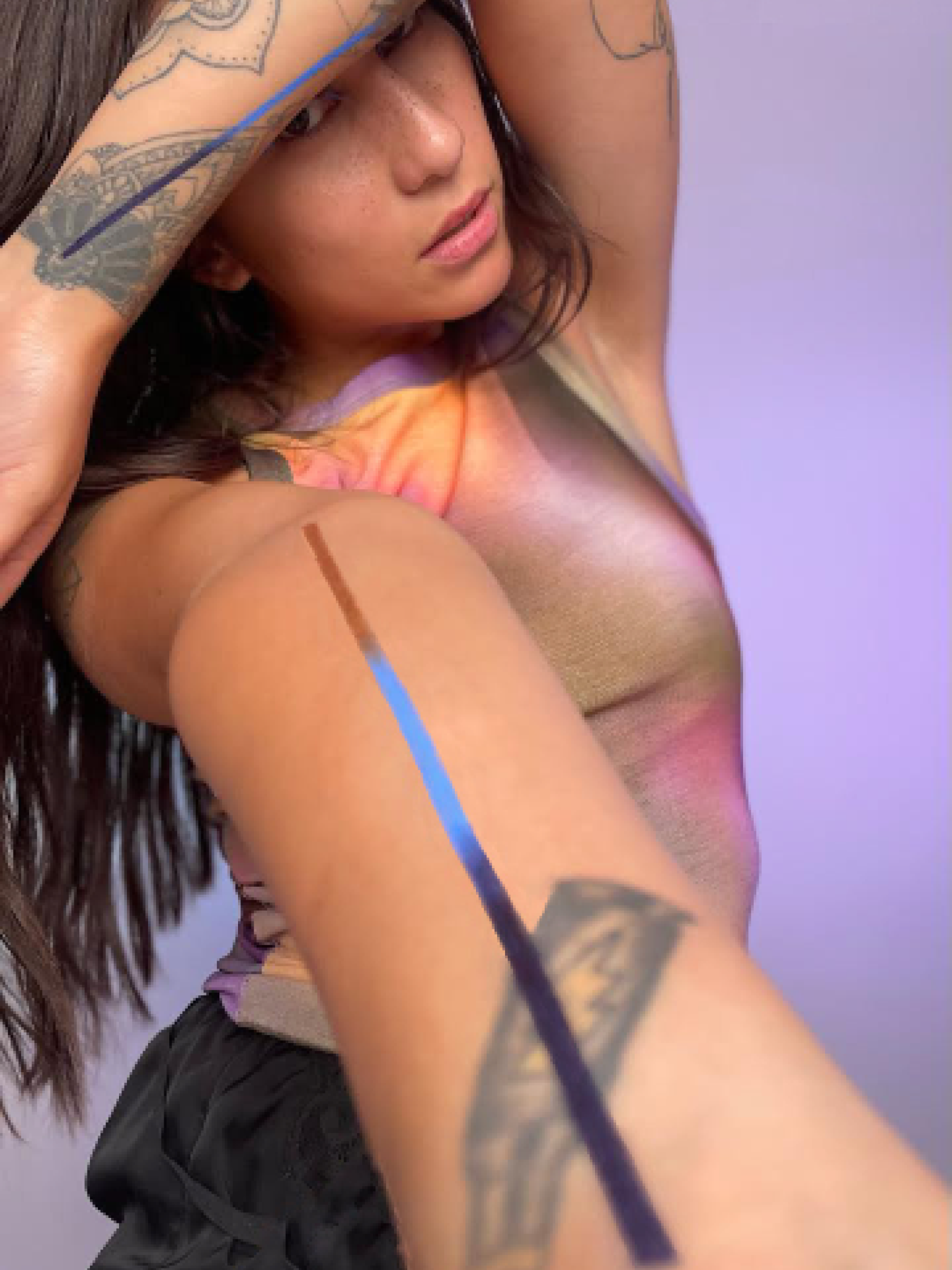 Model with arm outstretched showing a line down the center of their inner arm made with humanoid tape.