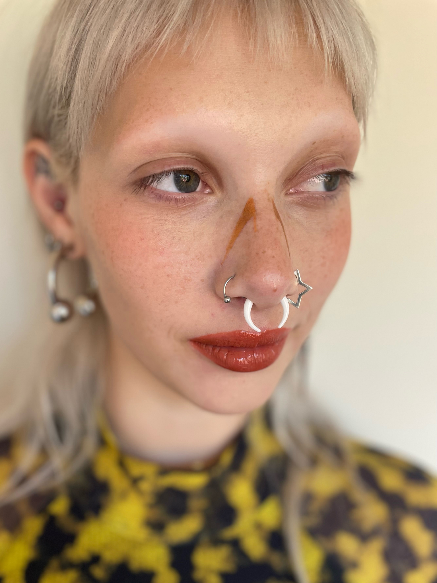 Model with light skin tone wearing a deepdive colorpot in Eventide along their nose