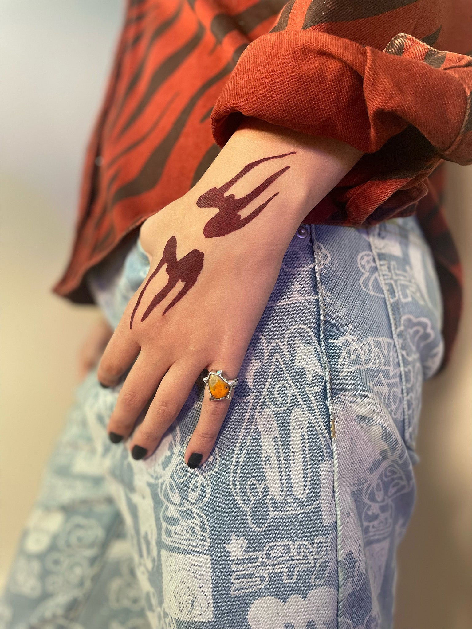 Model with light skin tone wearing a Deepdive colorpot in Aeonium on the back of their hand.