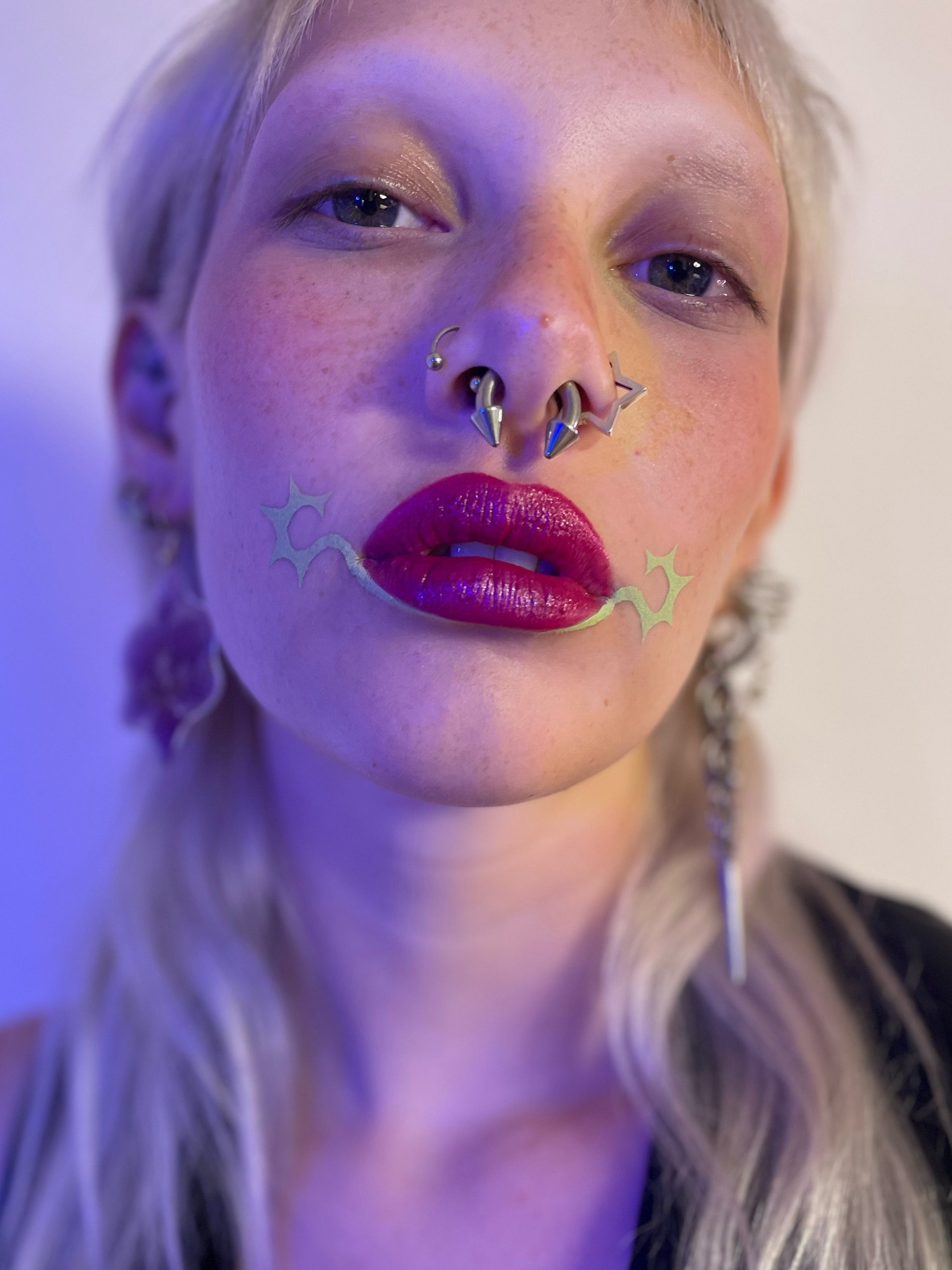 Model wearing Sagebrush under bottom lip with starburst at corners of their mouth.
