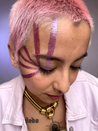 Model with medium skin wearing glabra in vertical stripes down the right side of their face. Applied using humanoid tape.