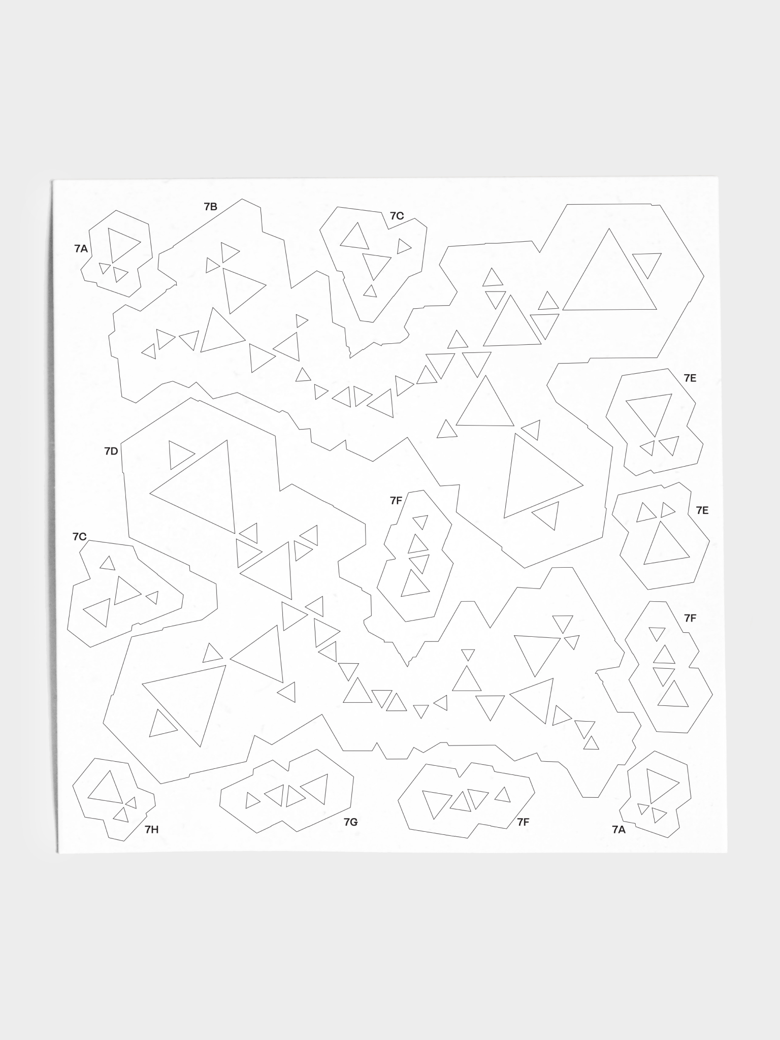 Closeup of stencil sheet with various triangle patterns.