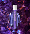 Close-up of colorwand Costas, a rich indigo duo-chrome with fuschia and gold metallic shimmer