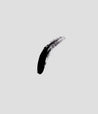 black corvid liquid makeup product smeared in a single line on a grey background