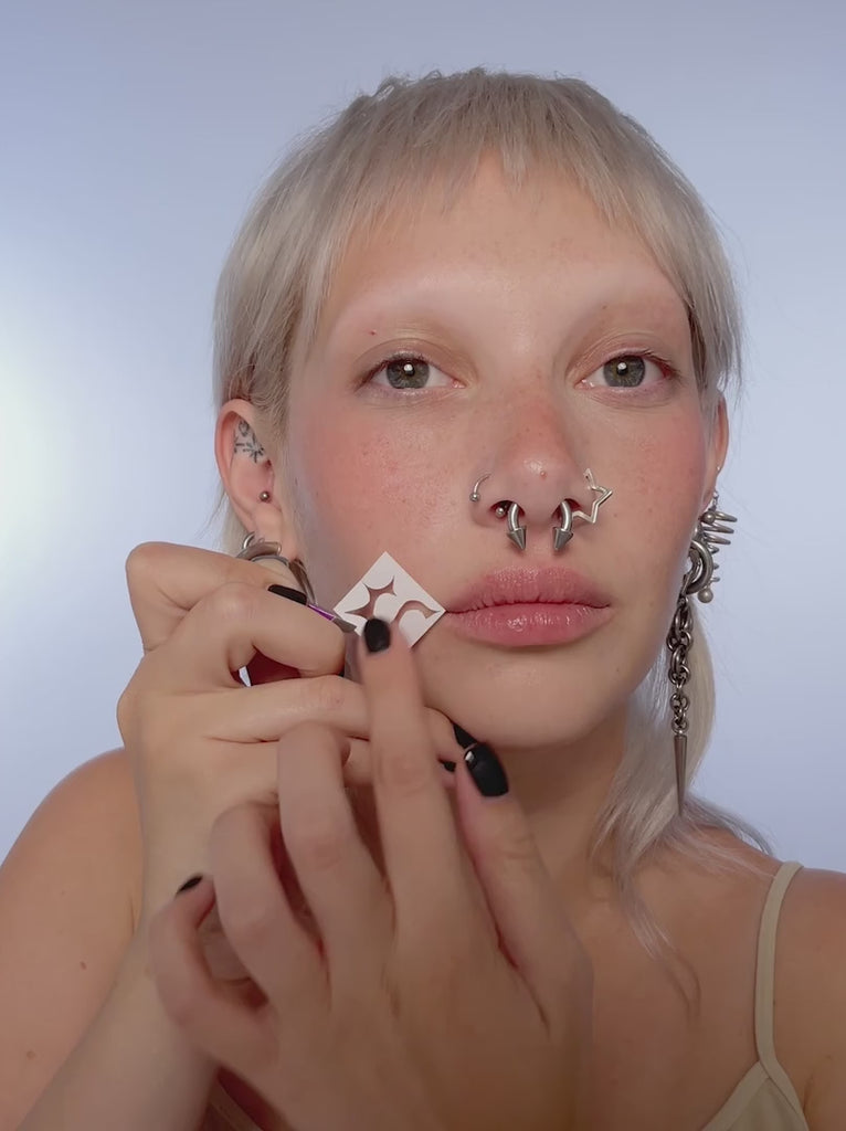 Video of model using stencils on their face.