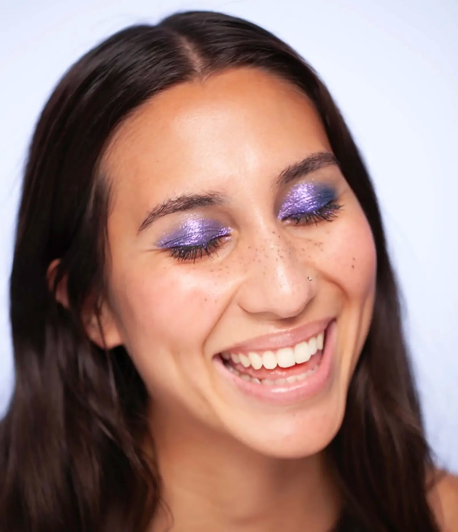 var:costas | close-up of costas gel wand makeup worn on eyes showing duo-chrome indigo finish
