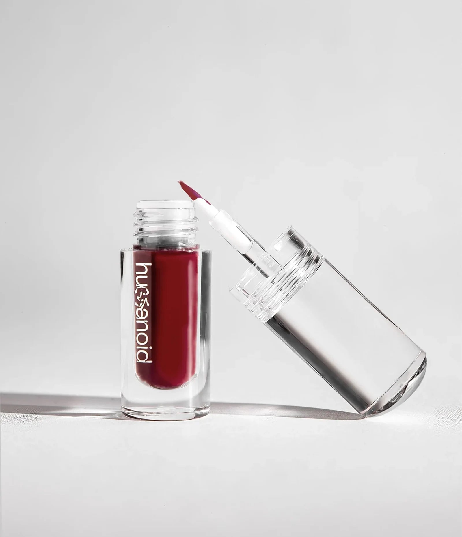var:aeonium | aeonium deepdive makeup  in a clear acrylic bottle with brush tip, color opaque matte burnt brick red