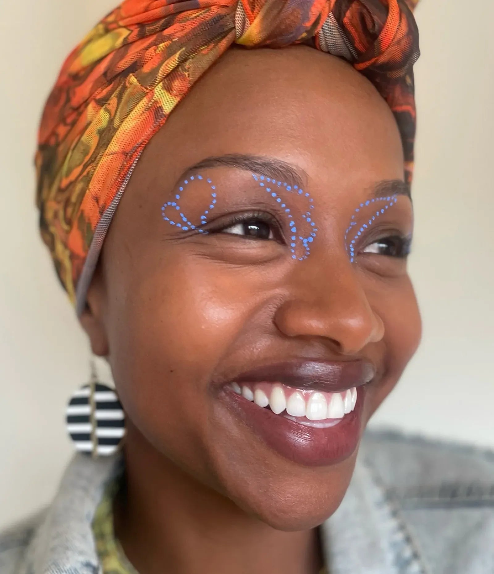 var:benitoite | closeup of smiling model wearing humanoid benitoite deepdive pigment matte cornflower blue in dot patterns around her eyes